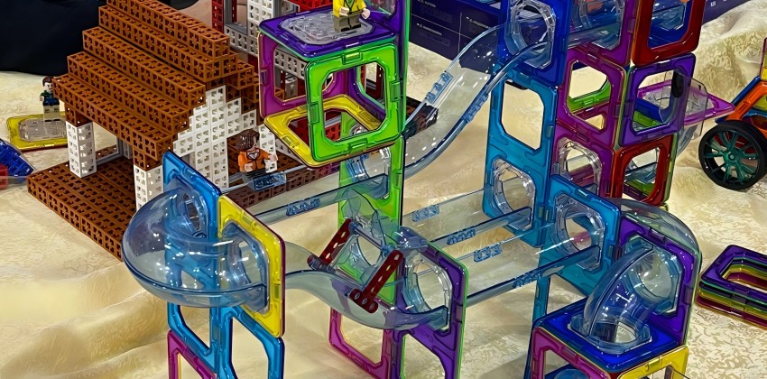 A plastic toy made from transparent polycarbonate (PC) material, available in various colors.