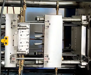 A 3-plate mold for plastic handles consisting of three main sections.