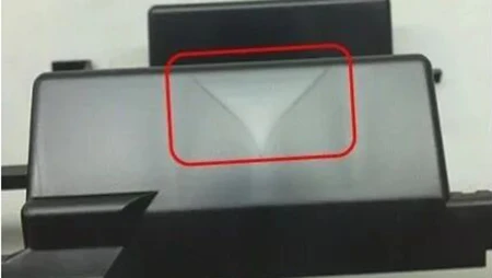 Weld lines in plastic injection-moulded part showing weak surface lines where molten flows meet.